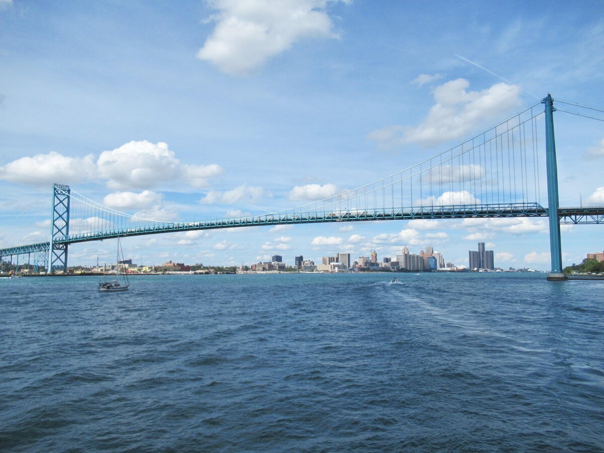 The Ambassador Bridge spanning the Detroit River, with the Detroit skyline behind it